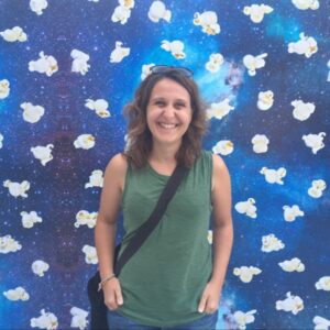 Carolina smiling in front of a patterned background